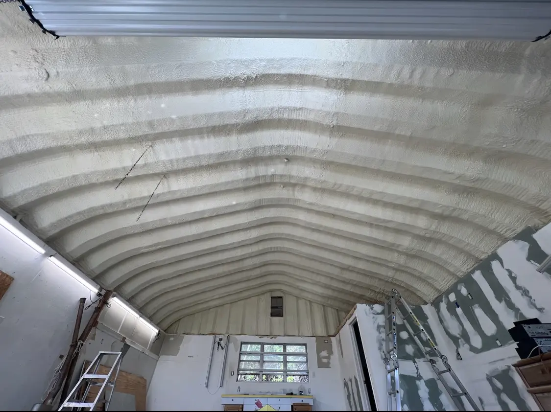 Spray polyurethane foam applied to the underside of a metal roof deck in Monticello